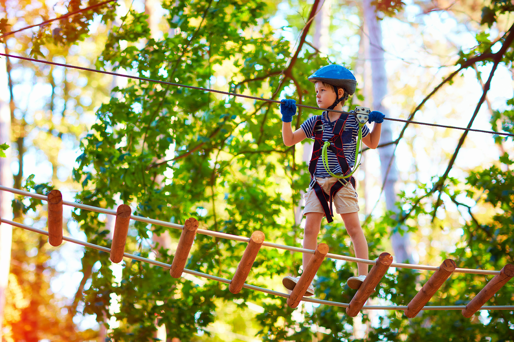 Young boy on a cable engaging in team building activities for kids